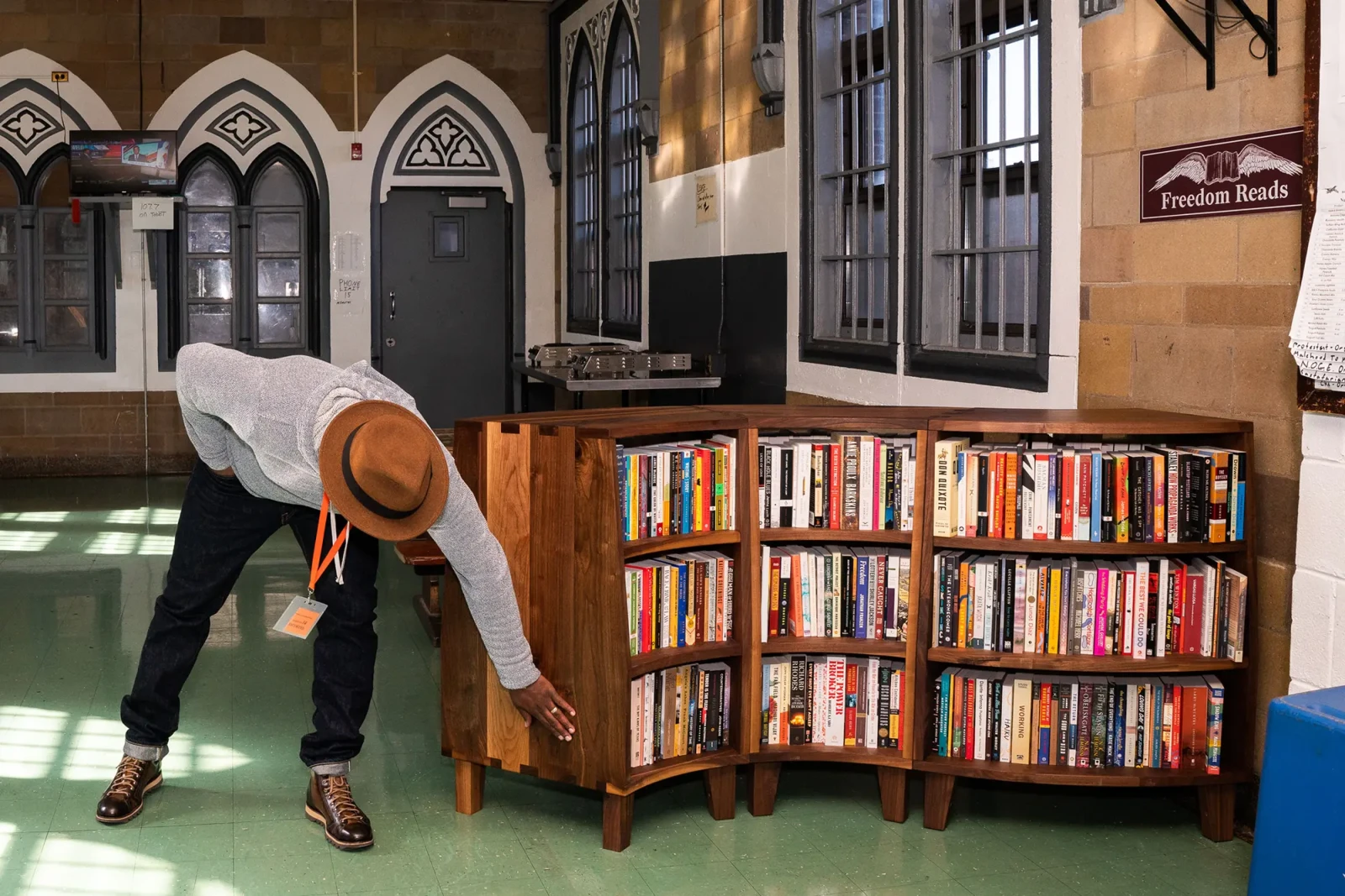 Freedom Reads Founder & CEO Reginald Dwayne Betts with a Freedom Library at Woodbourne Correctional Facility in New York. Freedom Reads Founder & CEO Reginald Dwayne Betts leans down, passing his hand appreciatively over the smooth, curving wood of a newly opened and fully stocked Freedom Library at Woodbourne Correctional Facility in New York.