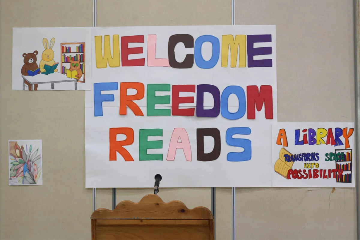 a welcome sign hangs on wall