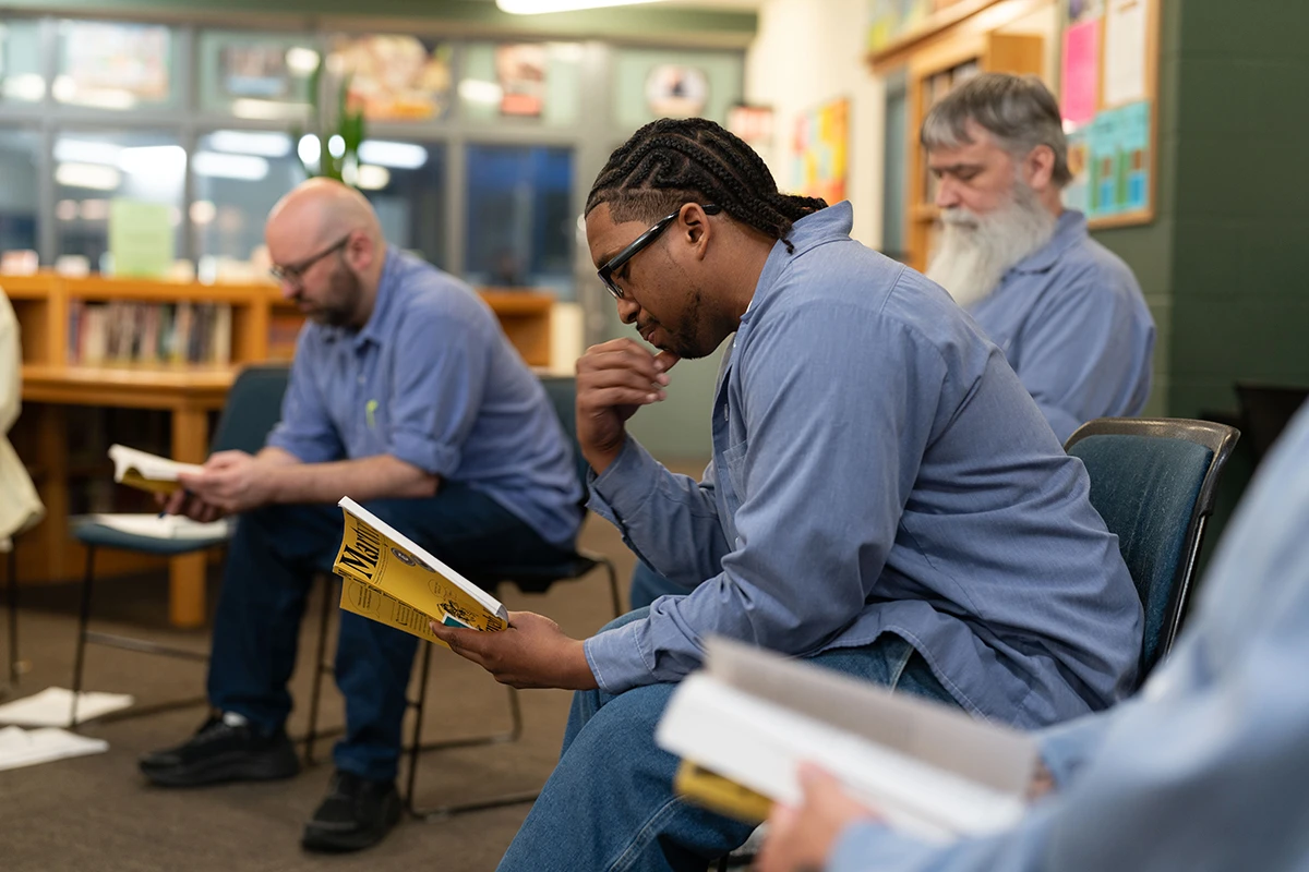 men sitting down reading books