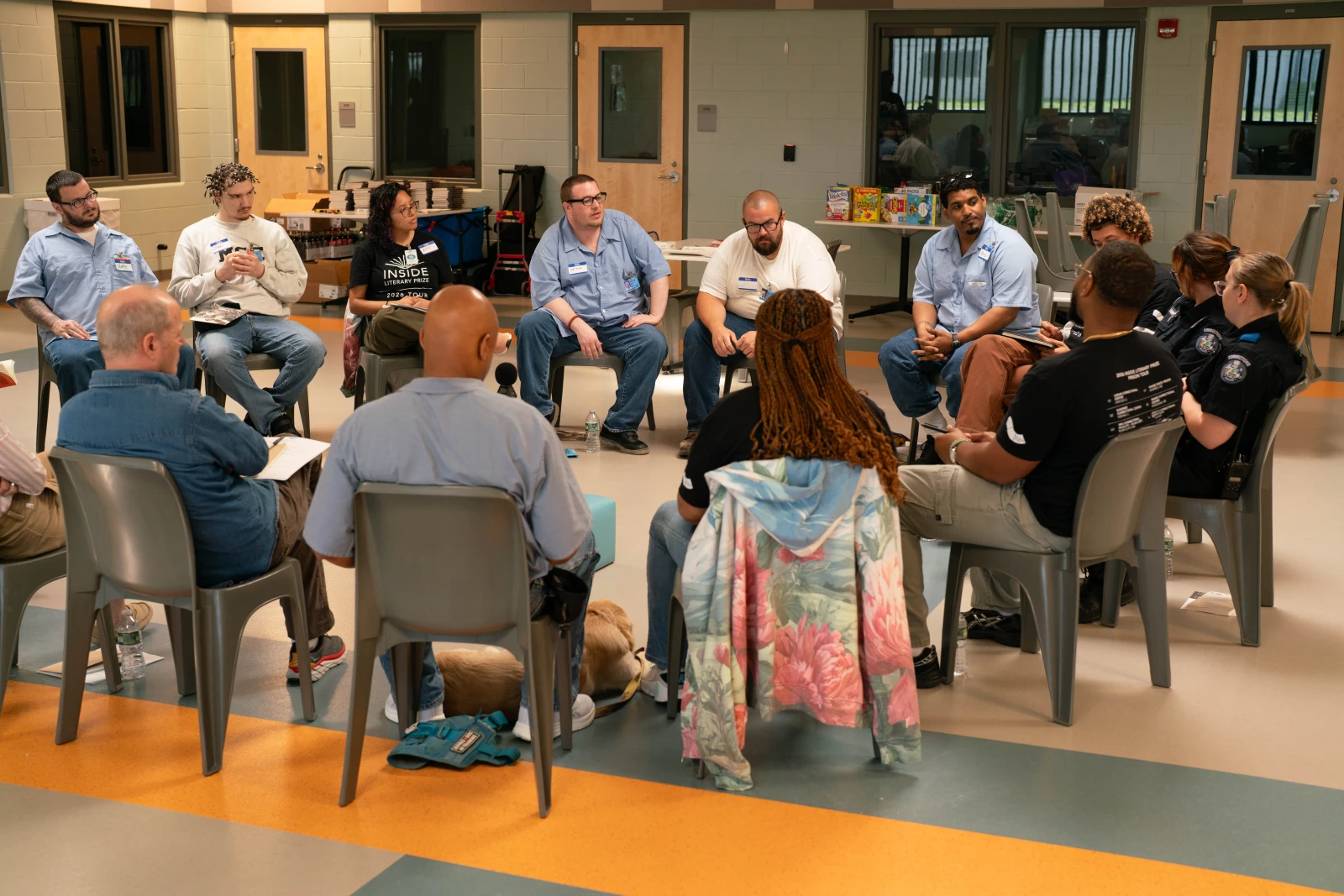 People sitting on chairs in a circle.
